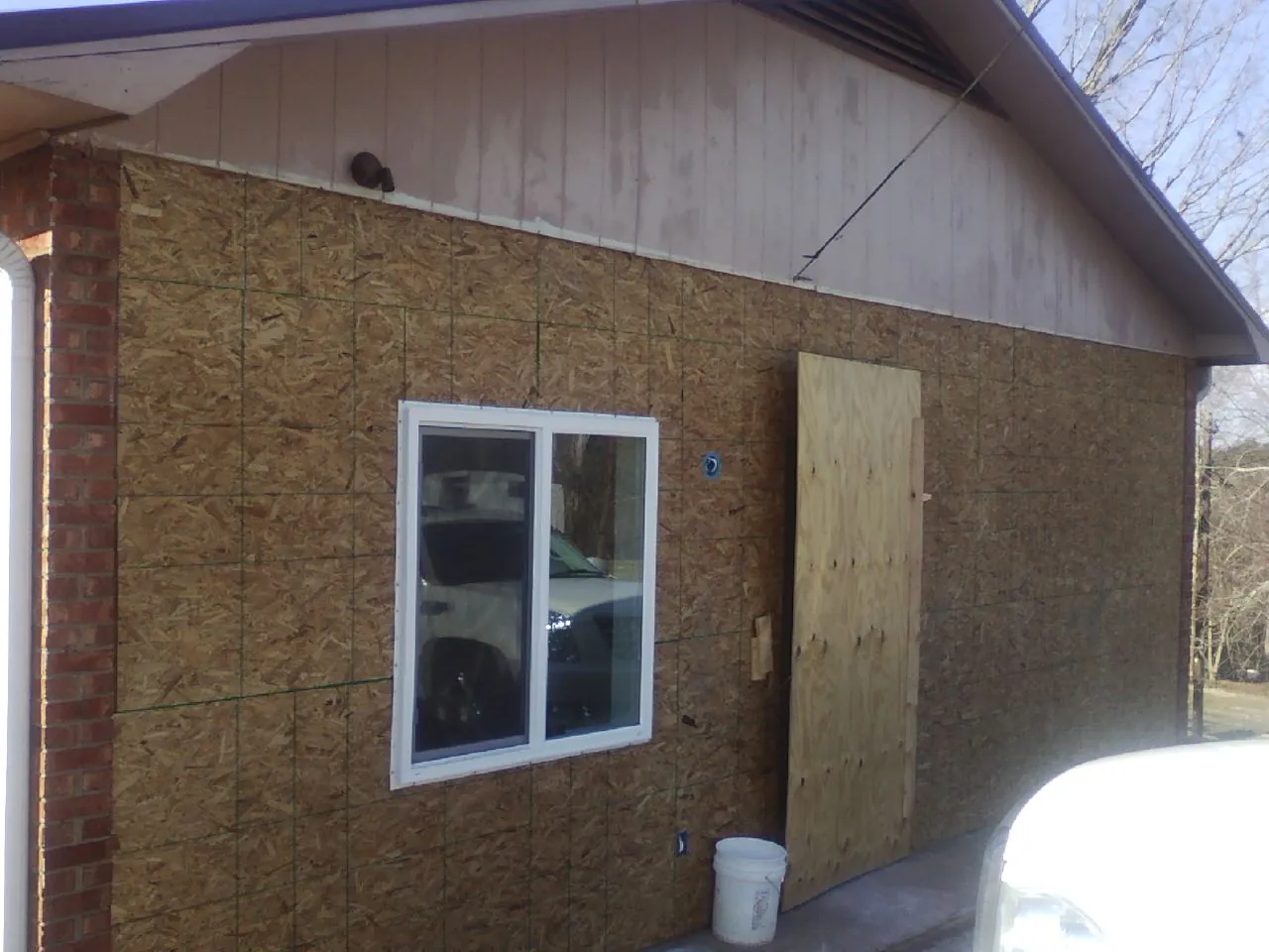 OSB sheathing on a garage addition wall before siding in Logsden
